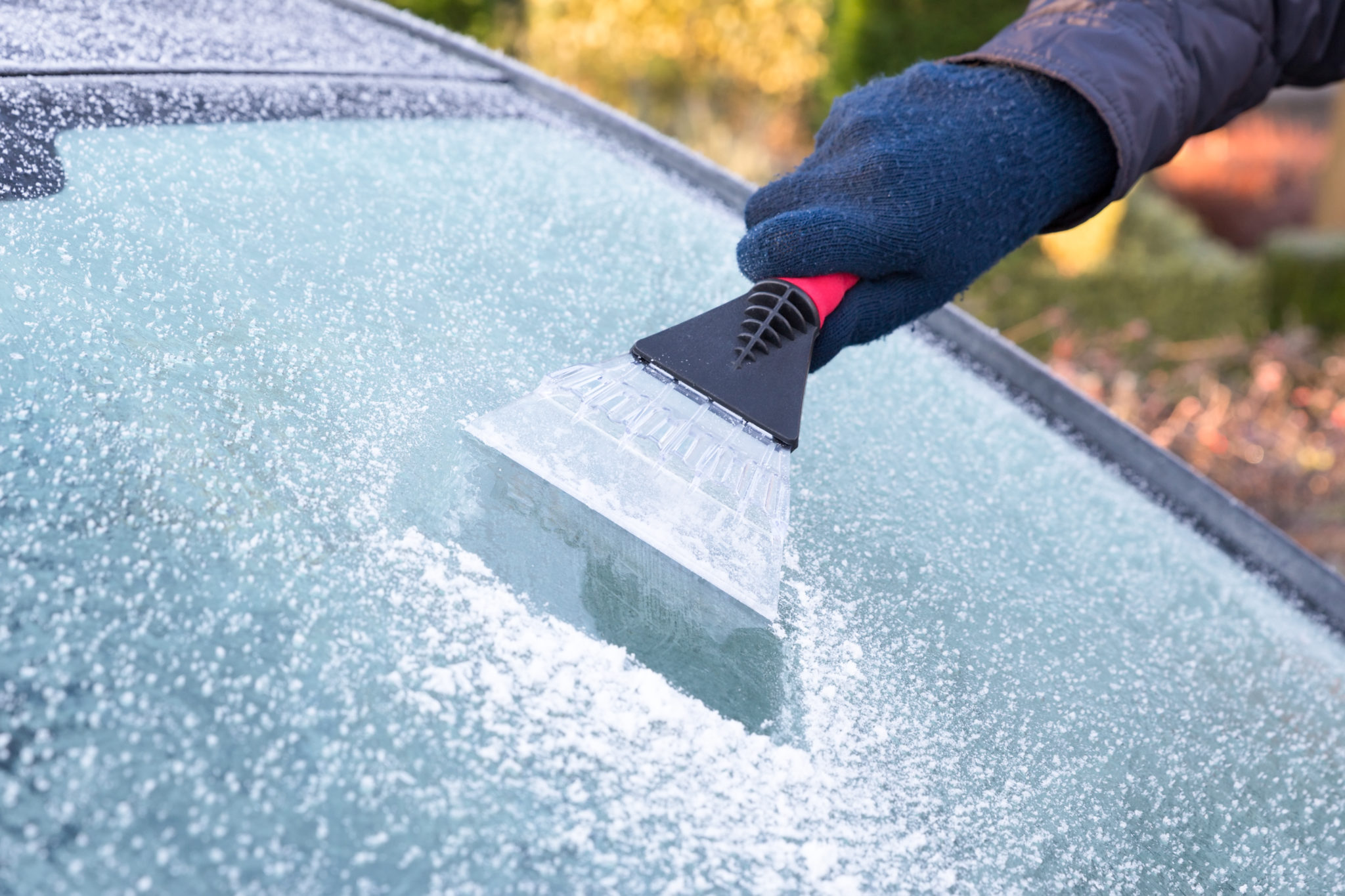 Hand Scraping a Windshield 